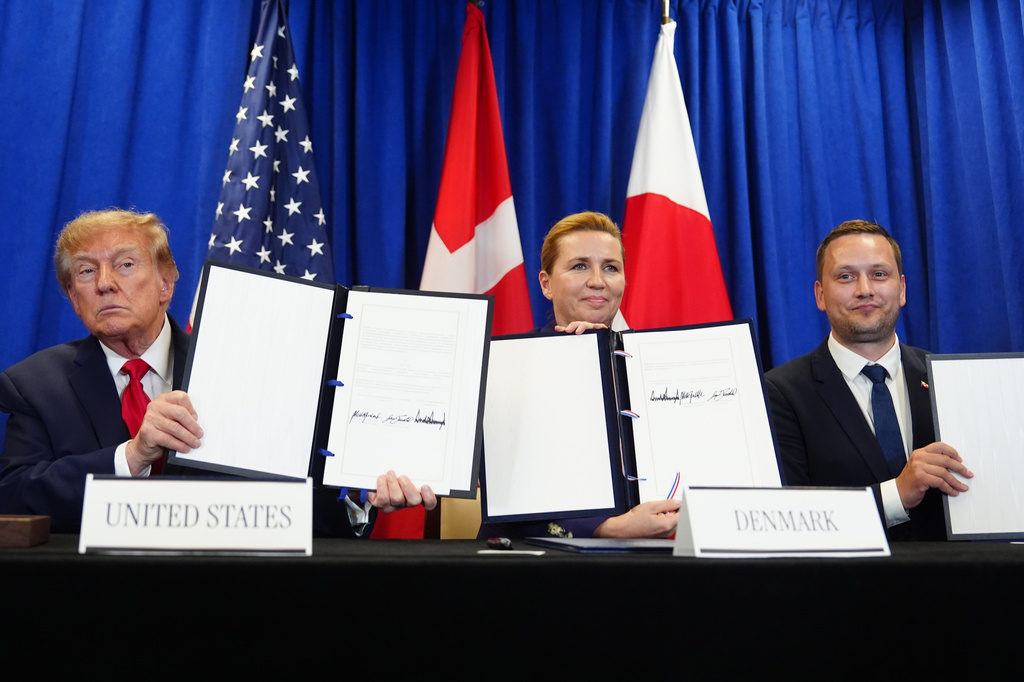 President Donald Trump signs a security agreement with Denmark's Prime Minister Mette Frederiksen and Greenland's Prime Minister Jens-Frederik Nielsen during the United Nations General Assembly, Tuesday, Sept. 22, 2026, at the UN headquarters. (AP Photo/Julia Demaree Nikhinson)