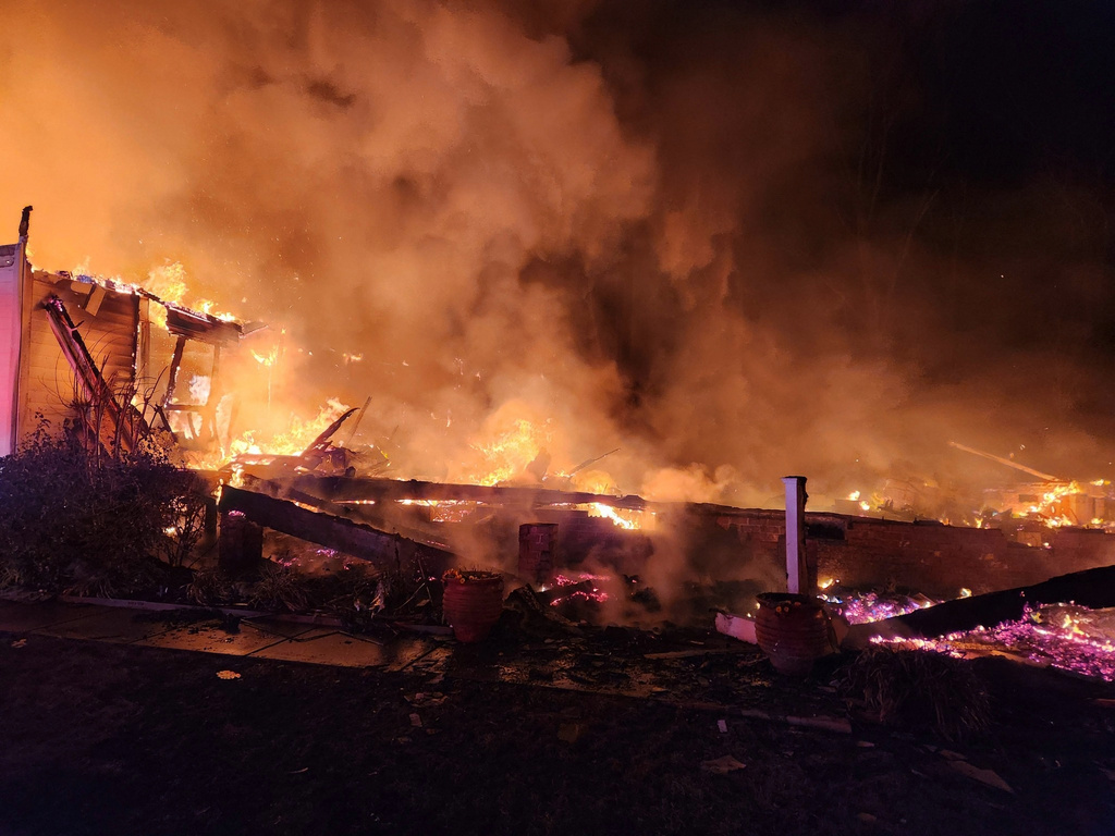 This photo provided by Lucia-Riverbend Fire Department, flames fill from a house fire fill the air late Sunday, Dec. 28, 2025 in Stanley, NC. (Brian Lee Weyeneth/Lucia-Riverbend Fire Department via AP)