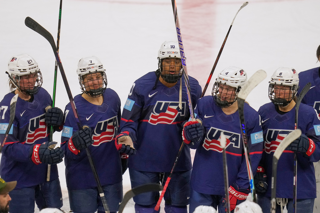 FILE - US's Taylor Heise (27), Lacey Eden (7), Laila Edwards (10) Caroline Harvey (4) and Haley Winn (8) celebrate with teammates after the US defeated Canada in a Rivalry Series women's hockey game Thursday, Nov. 6, 2025, in Cleveland. (AP Photo/Sue Ogrocki, File)