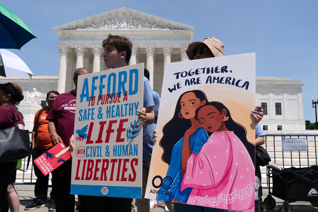 Activists celebrate the Supreme Court's ruling on birthright citizenship, outside of the Supreme Court on Capitol Hill, Tuesday, June 30, 2026, in Washington. (AP Photo/Jose Luis Magana)