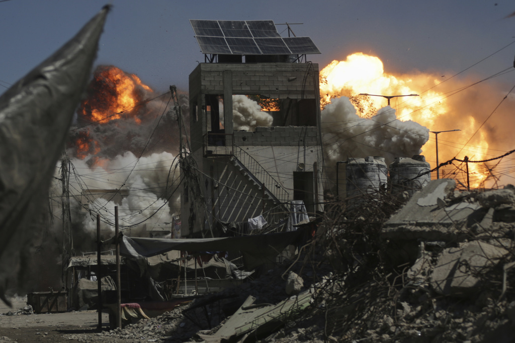 Smoke and flames rise after an Israeli military strike on a building in Gaza City, Saturday, Sept. 13, 2025. (AP Photo/Yousef Al Zanoun)