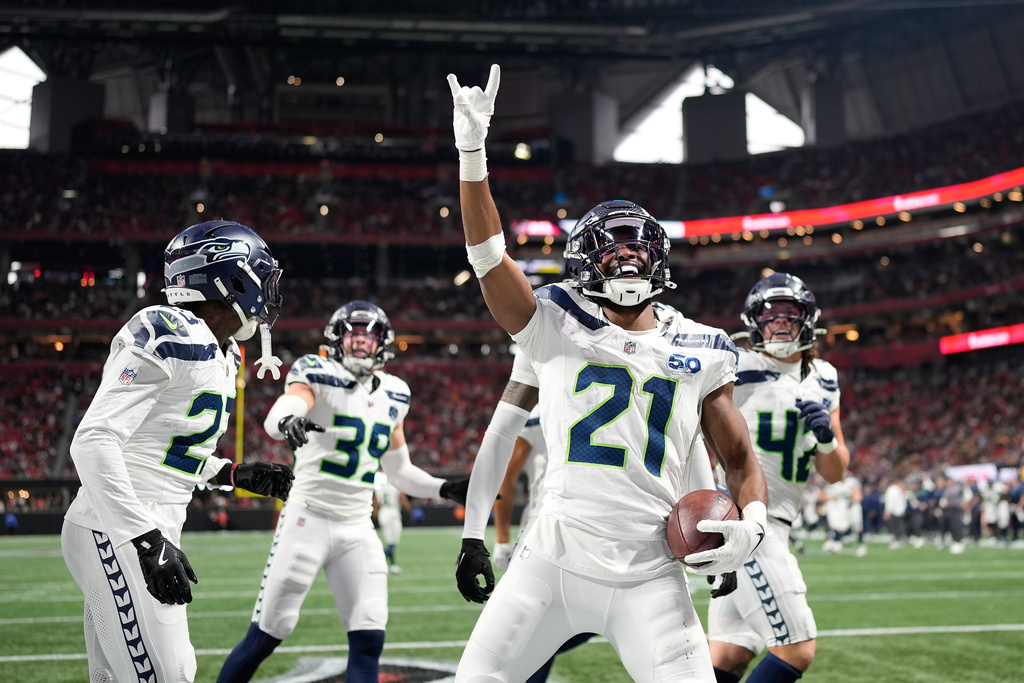 Seattle Seahawks cornerback Devon Witherspoon celebrates a fumble recovery against the Atlanta Falcons during the second half of an NFL football game, Sunday, Dec. 7, 2025, in Atlanta. (AP Photo/Mike Stewart)