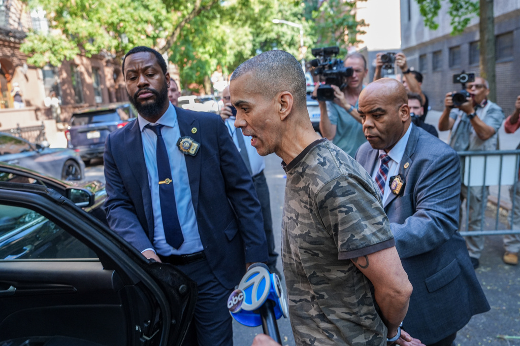 Raul Morales, a 51-year-old man who is accused of stabbing two people on the Upper West Side in Manhattan on Thursday afternoon is escorted out of the NYPD 20th Precinct by police officers in New York, Friday, July 24, 2026. (AP Photo/Ryan Murphy)