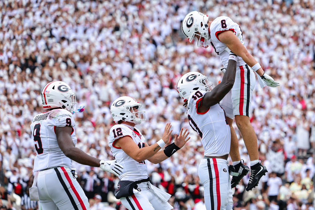 Georgia wide receiver Landon Roldan, right, is lifted into the air by tight end Elyiss Williams (10) after scoring a touchdown during the first half of an NCAA college football game against Western Kentucky, Saturday, Sept. 12, 2026, in Athens, Ga. (AP Photo/Colin Hubbard)
