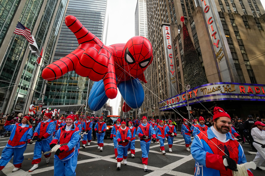 Balloon handlers guide the Spider Man balloon past Radio City Music Hall during the Macy's Thanksgiving Day Parade, Thursday, Nov. 27, 2025, in New York. (AP Photo/Eduardo Munoz Alvarez)