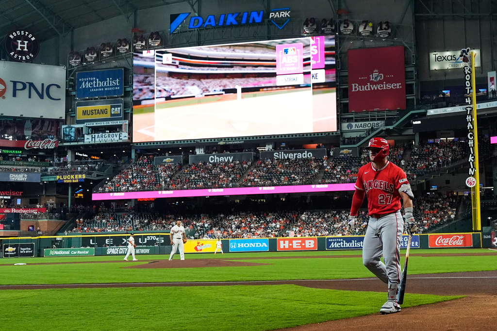 Los Angeles Angels designated hitter Mike Trout reacts after striking out as the ABS replay shows on the screen during the first inning of a baseball game against the Houston Astros in Houston, Sunday, March 29, 2026. (AP Photo/Ashley Landis)