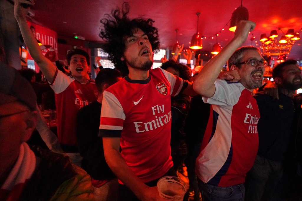Arsenal supporters celebrate as they watch the Premier League match between Bournemouth and Manchester City in a pub near the Arsenal stadium in London, Tuesday, May 19, 2026.(AP Photo/Alberto Pezzali)