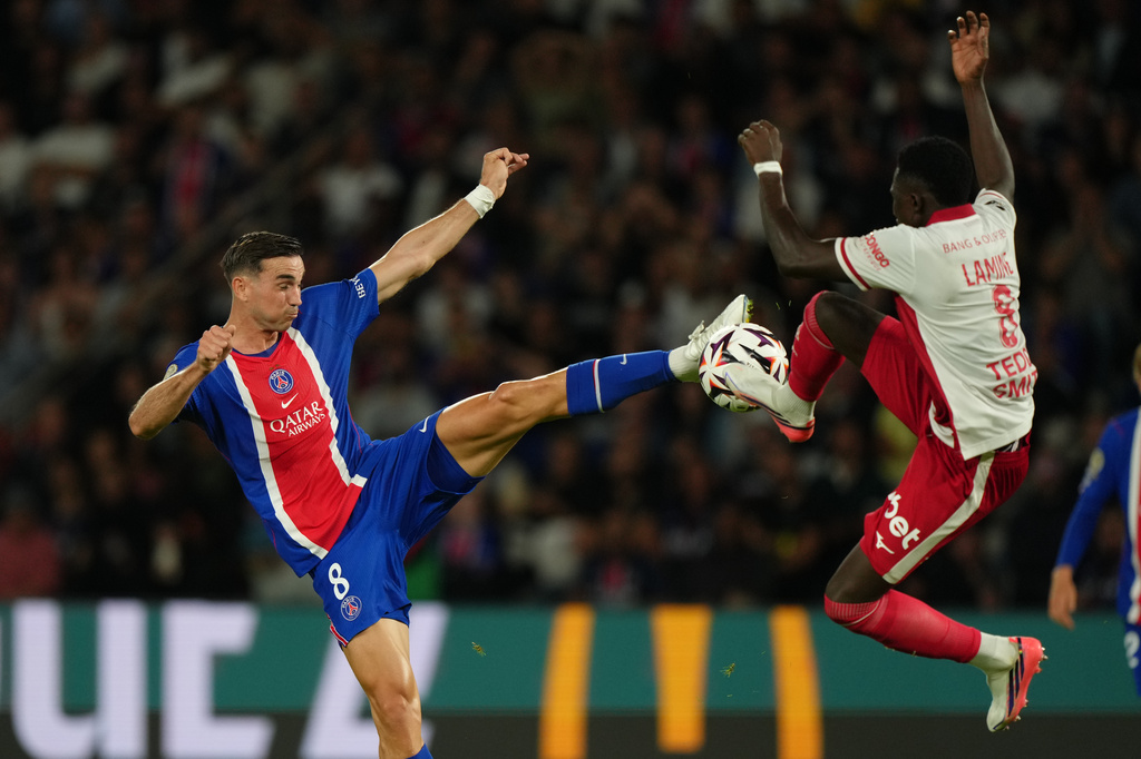 PSG's Fabian Ruiz, left, challenges for the ball with Monaco's Lamine Camara during the French League One soccer match between Paris Saint-Germain, and Monaco, in Paris, France, Friday, Sept. 4, 2026. (AP Photo/Aurelien Morissard)
