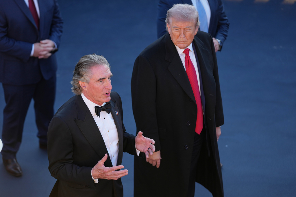 President Donald Trump listens as Interior Secretary Doug Burgum speaks at the Lincoln Memorial Reflecting Pool during a visit to to see the new blue protective coating being applied as part of a renovation project, Thursday, May 7, 2026, in Washington. (AP Photo/Mark Schiefelbein)