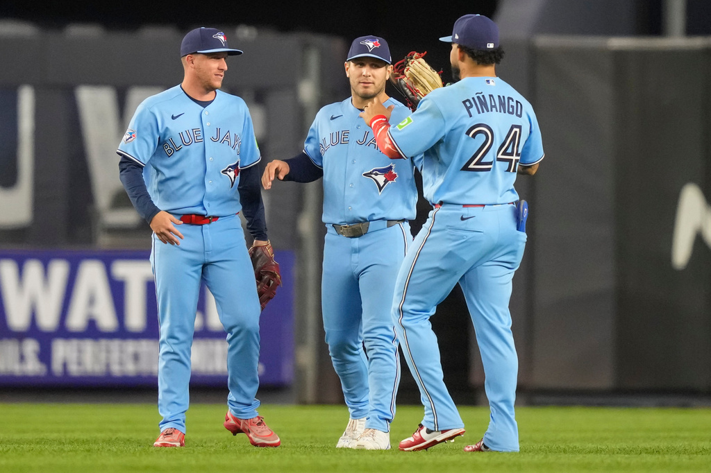 Toronto Blue Jays left fielder Yohendrick Piñango, right, center fielder Daulton Varsho, center, and right fielder Myles Straw celebrate after winning a baseball game against the New York Yankees, Wednesday, May 20, 2026, in New York. (AP Photo/Yuki Iwamura)