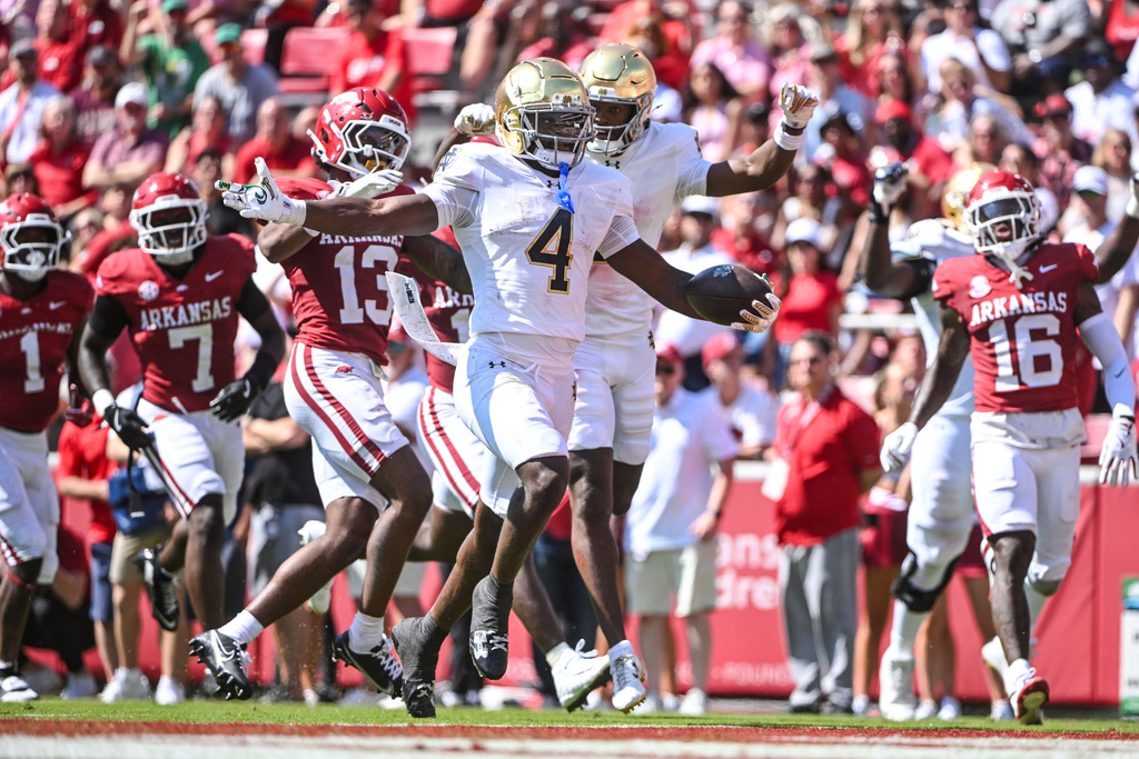 Notre Dame running back Jeremiyah Love (4) celebrates as he scores a touchdown against Arkansas during the first half of an NCAA college football game Saturday, Sept. 27, 2025, in Fayetteville, Ark. (AP Photo/Michael Woods)