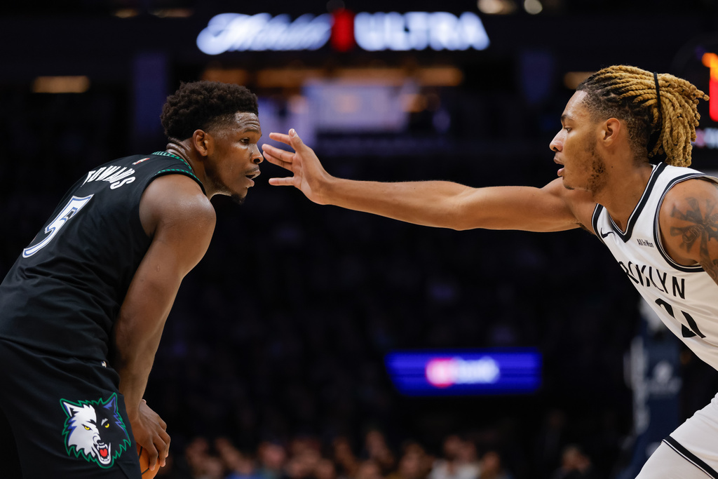 Minnesota Timberwolves guard Anthony Edwards (5) handles the ball while Brooklyn Nets forward Noah Clowney defends during the first half of an NBA basketball game, Saturday, Dec. 27, 2025, in Minneapolis. (AP Photo/Bailey Hillesheim)