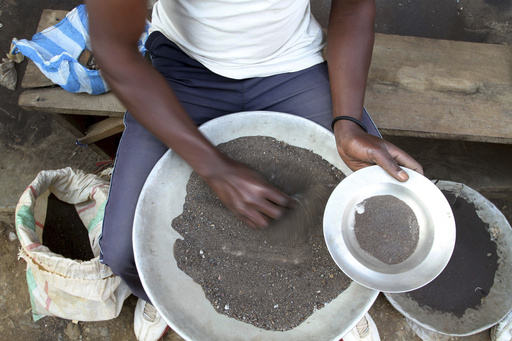 FILE - A Congolese miner sifts through ground rocks to separate out the cassiterite, the main ore that's processed into tin, in the town of Nyabibwe, eastern Congo, Aug. 16, 2012. Congo&rsquo;s government is questioning Apple about the tech company&rsquo;s knowledge of &ldquo;blood minerals&rdquo; from a conflict zone in the African country that could be smuggled into supply chains. A group of international lawyers representing Congo said Thursday, April 25, 2024, that it sent letters to Apple&rsquo;s CEO Tim Cook and its French subsidiary this week raising concerns about human rights violations involving the minerals extracted from mines in the country&rsquo;s war-torn east. (AP Photo/Marc Hofer, File)