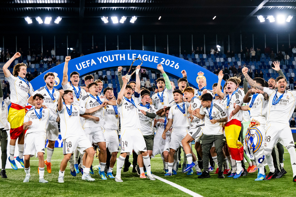 Real Madrid's players celebrate with the trophy after winning the Youth League final soccer match between Club Brugge and Real Madrid in Lausanne, Switzerland, Monday, April 20, 2026. (Jean-Christophe Bott/Keystone via AP)