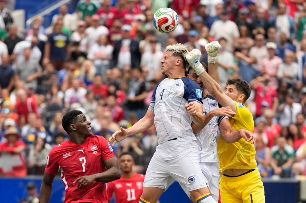 Bosnia goalkeeper Nikola Vasilj, right, clears the ball during the World Cup Group B soccer match between Switzerland and Bosnia in Inglewood, Calif., near Los Angeles, Thursday, June 18, 2026. (AP Photo/Andre Penner)