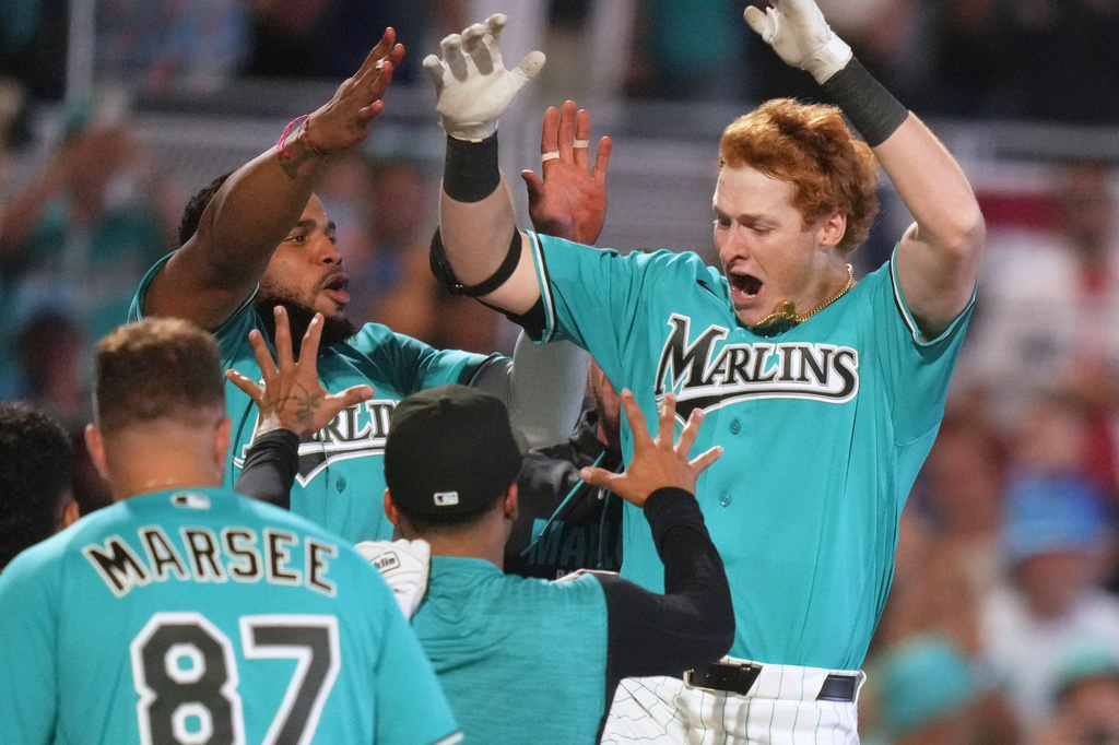 Miami Marlins' Owen Caissie, right, reacts after scoring on a walk-off two run home run to defeat the Colorado Rockies in a baseball game, Sunday, March 29, 2026, in Miami. (AP Photo/Lynne Sladky)