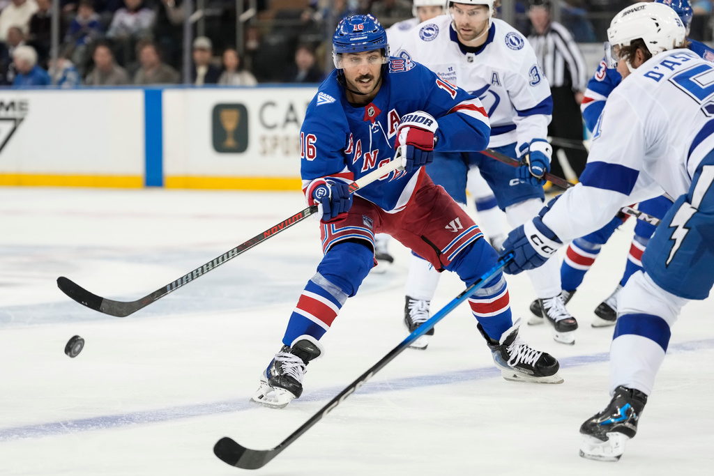 New York Rangers center Vincent Trocheck (16) shoots the puck past Tampa Bay Lightning defenseman Charle-Edouard D'Astous, right, during the third period of an NHL hockey game, Saturday, Nov. 29, 2025, in New York. (AP Photo/Yuki Iwamura)