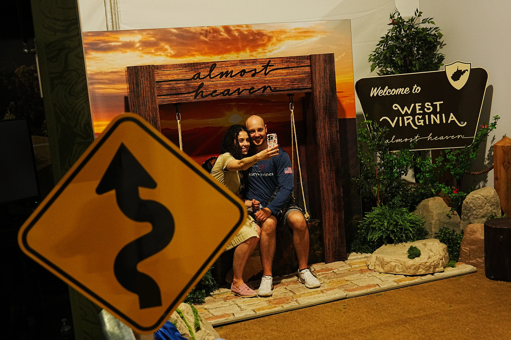 People take a selfie in the West Virginia exhibit at the Great American State Fair, Tuesday, June 30, 2026, on the National Mall in Washington. (AP Photo/Julia Demaree Nikhinson)