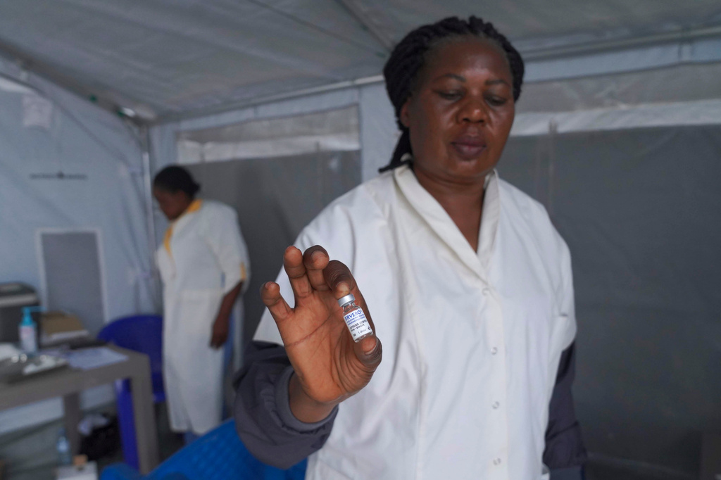 A healthcare worker holds up a vial of the Ervebo vaccine at an Ebola vaccination center in Bunia, Ituri province, Congo, Saturday, Sept. 19, 2026. (AP Photo/Dieudonne Dirole)