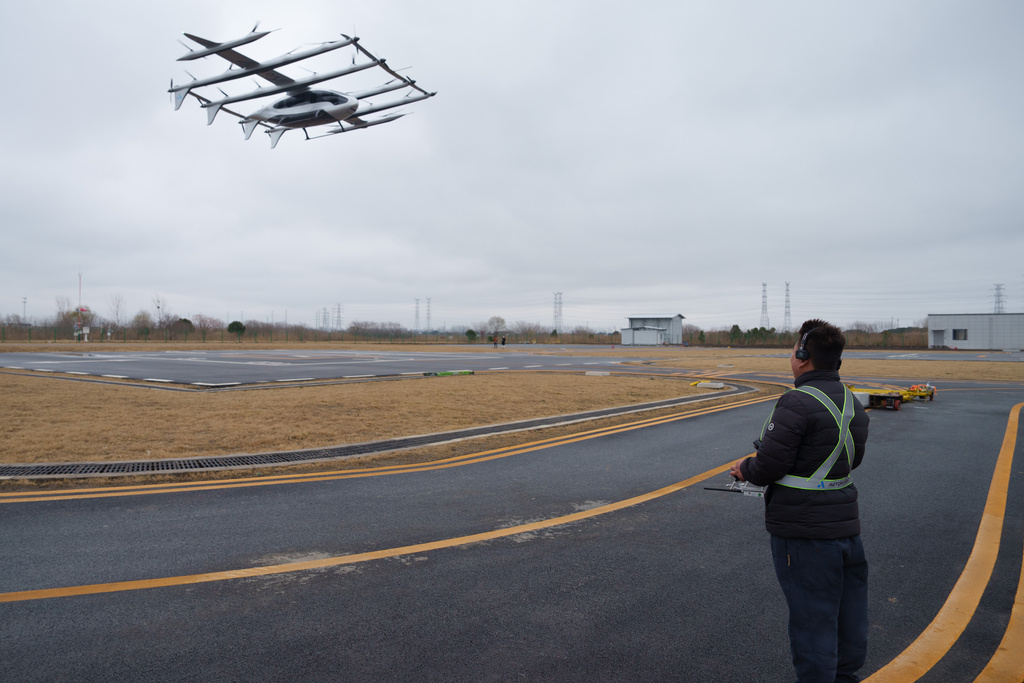 CORRECTS LOCATION A pilot monitors the landing of a 5-ton class eVTOL aircraft at AutoFlight flight testing field in Kunshan city in China's Jiangsu province, China, on Feb. 24, 2026. (AP Photo/Vincent Thian)