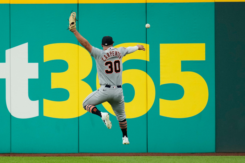 Detroit Tigers right fielder Kerry Carpenter (30) can't get to a ball hit for a double by Cleveland Guardians' Angel Martínez in the sixth inning of a baseball game in Cleveland, Friday, June 12, 2026. (AP Photo/Sue Ogrocki)