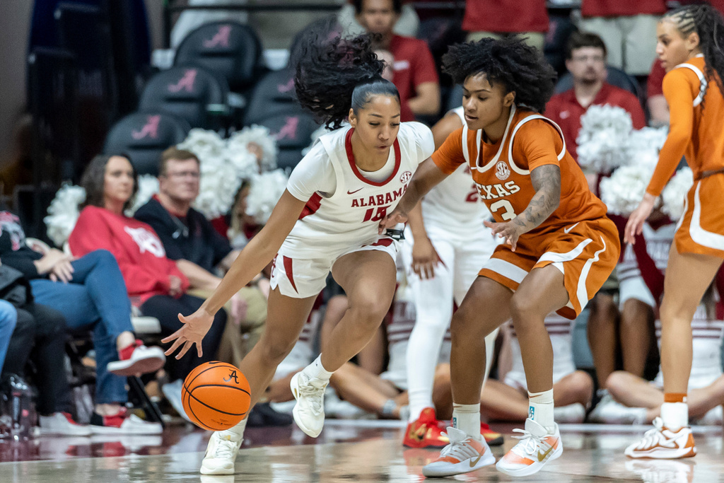 Alabama guard Ta'Mia Scott (15) works against Texas guard Rori Harmon (3) during the first half of an NCAA college basketball game Sunday, March 1, 2026, in Tuscaloosa, Ala. (AP Photo/Vasha Hunt)