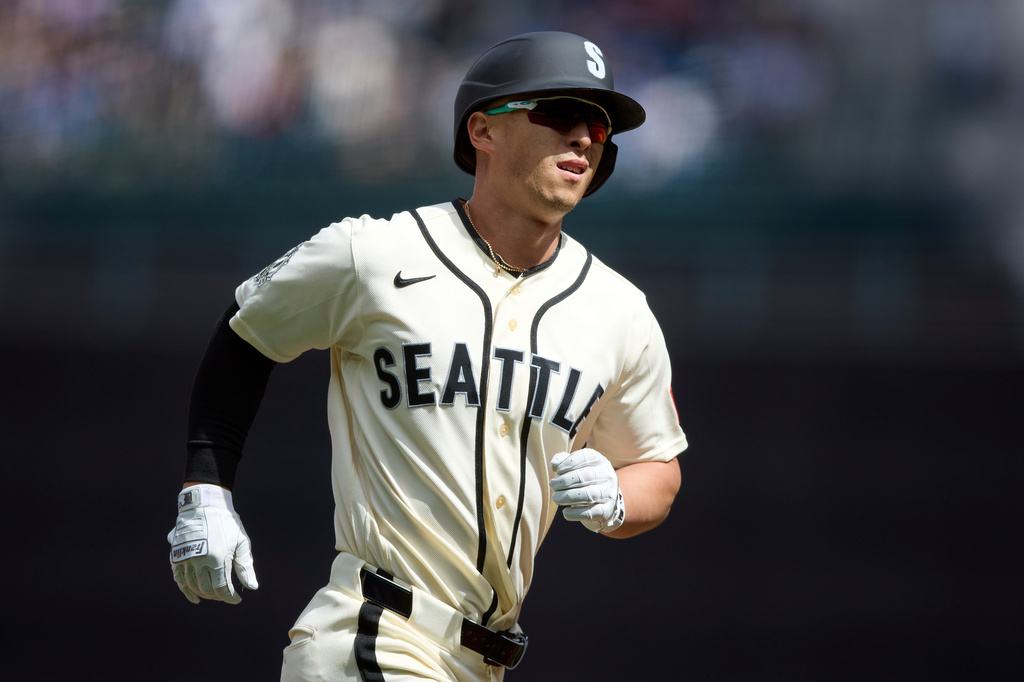 Seattle Mariners' Rob Refsnyder rounds the bases on a solo home run off Texas Rangers starting pitcher MacKenzie Gore during the first inning in a baseball game Sunday, April 19, 2026, in Seattle. (AP Photo/John Froschauer)