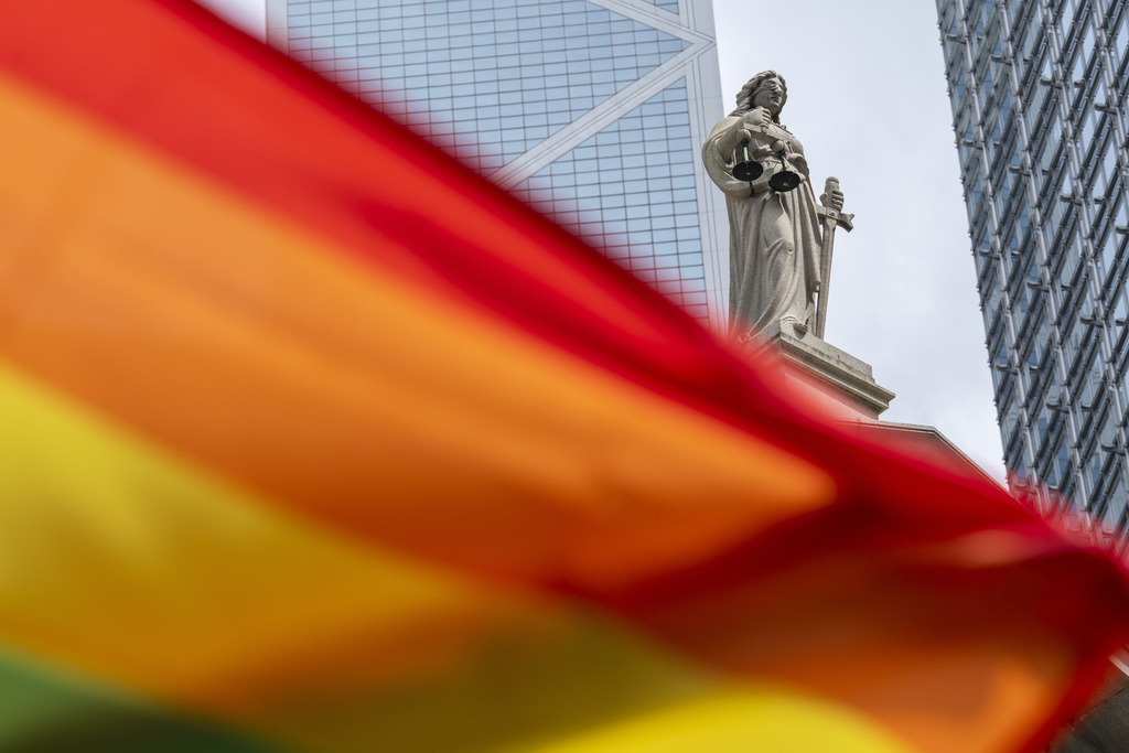 A rainbow flag is posed for photos in front of the court of final appeal in Hong Kong, Sunday, Aug. 24, 2025. (AP Photo/Chan Long Hei)