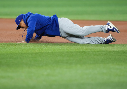 Los Angeles Dodgers manager Dave Roberts wipes out and falls while running the bases during World Series baseball batting practice World Series in Toronto, Thursday, Oct. 30, 2025. (Nathan Denette/The Canadian Press via AP) Los Angeles Dodgers manager Dave Roberts wipes out and falls while running the bases during World Series baseball batting practice World Series in Toronto, Thursday, Oct. 30, 2025. (Nathan Denette/The Canadian Press via AP)