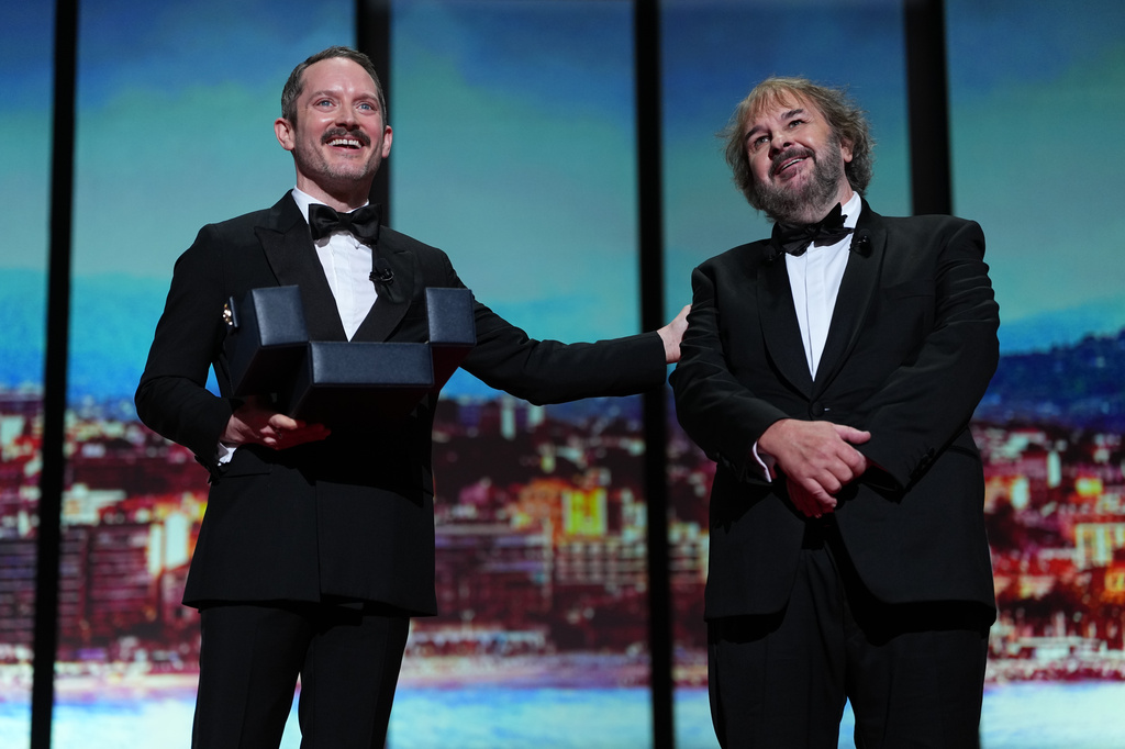 Elijah Wood, left, and director Peter Jackson, recipient of the honorary Palme d'Or, pose for photographers during the opening ceremony of the 79th international film festival, Cannes, southern France, Tuesday, May 12, 2026. (Photo by Scott A Garfitt/Invision/AP)
