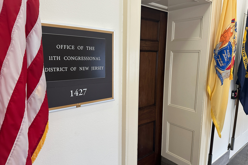 An American flag hangs outside the Office of the 11th Congressional District in the Longworth House Office Building in Washington on Thursday, April 2, 2026. (AP Photo/Robert Yoon)