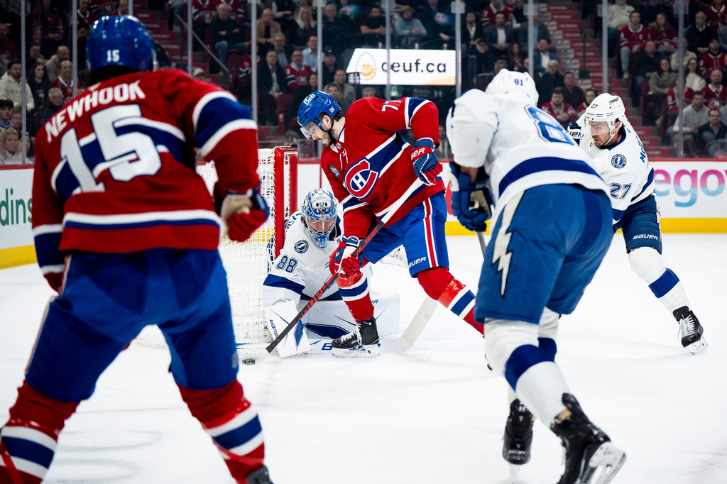 Tampa Bay Lightning goaltender Andrei Vasilevskiy (88) makes a save against Montreal Canadiens' Kirby Dach (77) during first-period NHL hockey game action in Montreal, Thursday, April 9, 2026. (Christopher Katsarov/The Canadian Press via AP)
