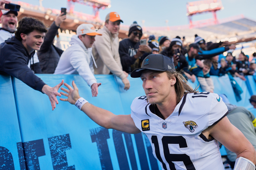 Jacksonville Jaguars quarterback Trevor Lawrence (16) high fives fans after defeating the Tennessee Titans in an NFL football game Sunday, Nov. 30, 2025, in Nashville, Tenn. (AP Photo/George Walker IV)