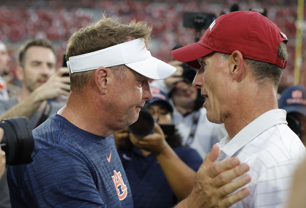 Auburn head coach Hugh Freeze and Oklahoma head coach Brent Venables meet mid field after their NCAA college football game Saturday, Sept. 20, 2025, in Norman, Okla. (AP Photo/Alonzo Adams)