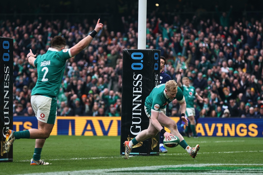Ireland's Jamie Osborne, right, scores a try as teammate Dan Sheehan celebrates during the Six Nations rugby union match between Ireland and Scotland, in Dublin, Saturday, March 14, 2026. (AP Photo/Peter Morrison)