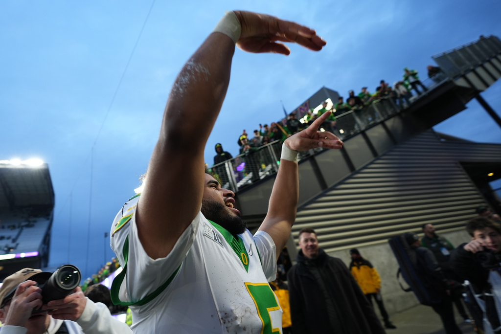 Oregon quarterback Dante Moore reacts towards fans after a win over Washington in an NCAA college football game, Saturday, Nov. 29, 2025, in Seattle. (AP Photo/Lindsey Wasson)