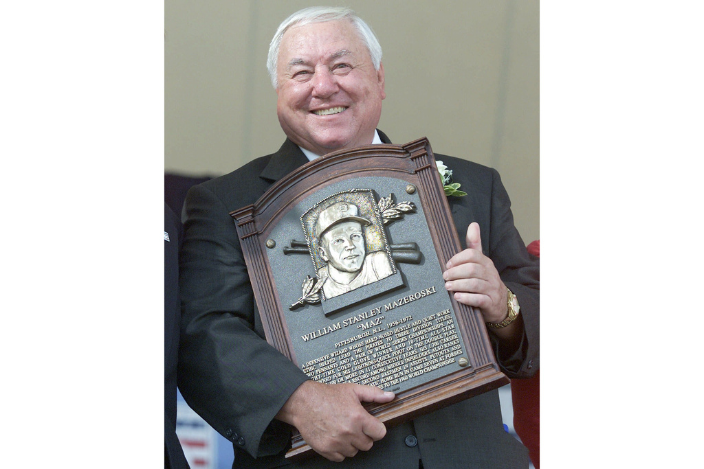 FILE - Former Pittsburgh Pirates player Bill Mazeroski holds onto his plaque during the 2001 National Baseball Hall of Fame induction ceremonies, Sunday, Aug. 5, 2001, in Cooperstown, N.Y. (AP Photo/John Dunn, File)
