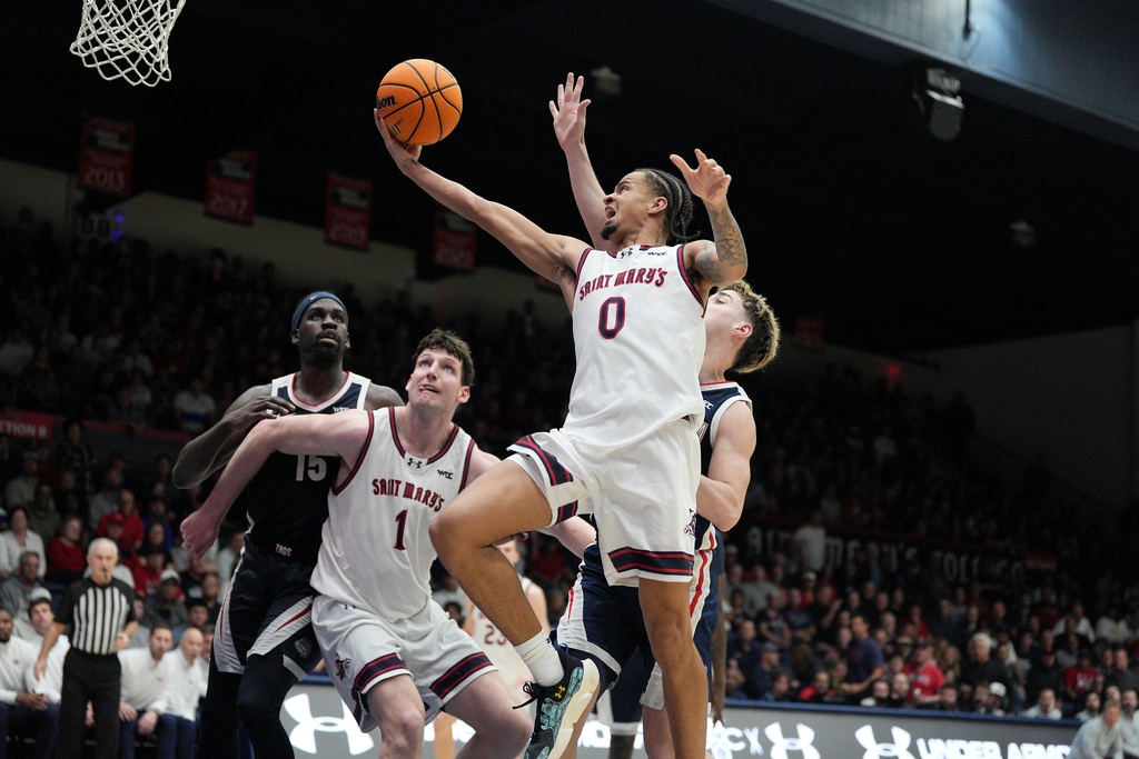 Saint Mary's guard Mikey Lewis (0) drives to the basket against Gonzaga guard Mario Saint-Supery, right, during the second half of an NCAA college basketball game in Moraga, Calif., Saturday, Feb. 28, 2026. (AP Photo/Tony Avelar)
