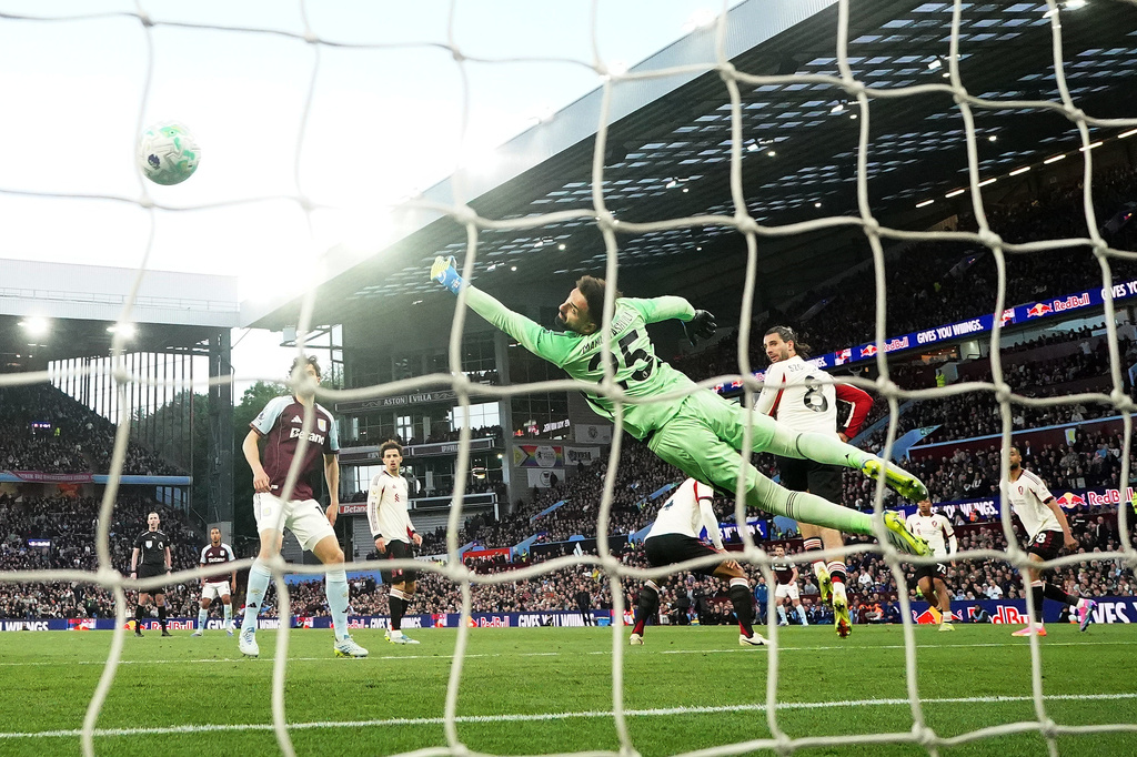 Liverpool goalkeeper Giorgi Mamardashvili fails to prevent Aston Villa's Morgan Rogers, not shown, from scoring during the English Premier League soccer match between Aston Villa and Liverpool in Birmingham, England, Friday, May 15, 2026. (David Davies/PA via AP)