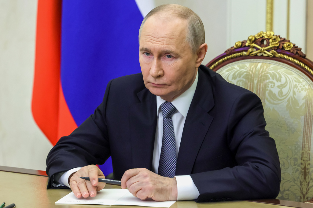 Russian President Vladimir Putin listens as Russian Strategic Missile Forces chief, Col. Gen. Sergei Karakayev reports to him on a successful test launch of the Sarmat intercontinental ballistic missile. at the Kremlin in Moscow, Tuesday, May 12, 2026. (Mikhail Metzel/Sputnik, Kremlin Pool Photo via AP)