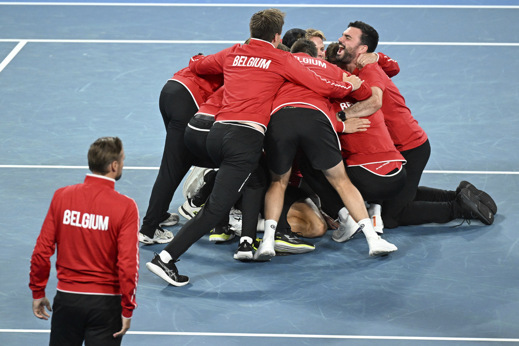 Belgium team run to congratulate Raphael Collignon after defeating Aleksandar Vukic of Australia to take the Davis Cup qualifying second round match at Ken Rosewall Arena in Sydney, Sunday, Sept. 14, 2025. (Dean Lewins/AAP Image via AP)