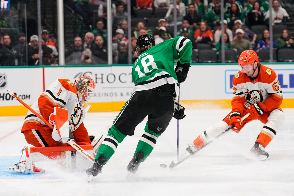 Anaheim Ducks' Lukas Dostal (1) and Jacob Trouba (65) defend against pressure from Dallas Stars center Sam Steel (18) in the first period of an NHL hockey game Thursday, Nov. 6, 2025, in Dallas. (AP Photo/Tony Gutierrez)