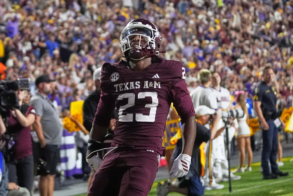 Texas A&M running back Jamarion Morrow (23) celebrates his touchdown in the second half of an NCAA college football game against LSU, Saturday, Oct. 25, 2025 in Baton Rouge, La. (AP Photo/Gerald Herbert)