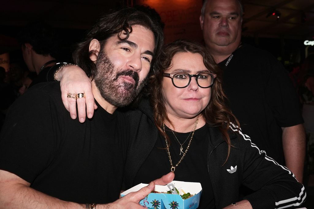 Rachael Ray and her husband John Cusimano react after eating a hamburger during the South Beach Wine and Food Festival's Burger Bash Friday Feb. 20, 2026, in Miami Beach, Fla. (AP Photo/Marta Lavandier)
