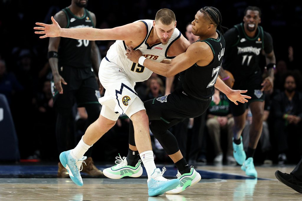 Denver Nuggets center Nikola Jokic, left, and Minnesota Timberwolves guard Jaylen Clark (22) get into an altercation during the second half of Game 6 of a first-round NBA basketball playoffs series, Thursday, April 30, 2026, in Minneapolis. (AP Photo/Matt Krohn)