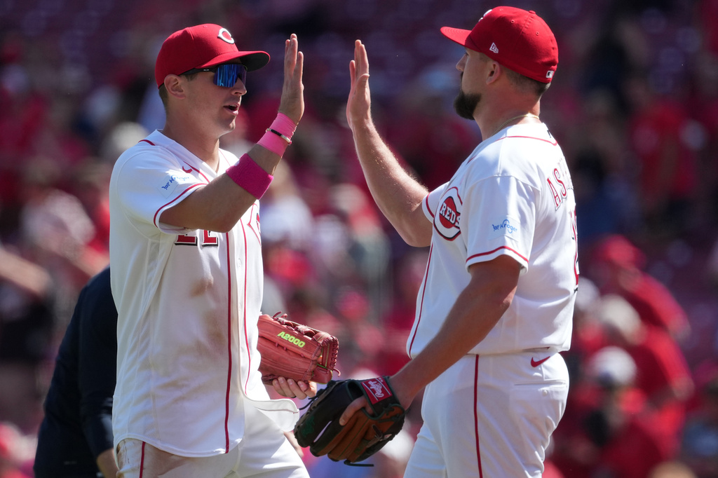 Cincinnati Reds' JJ Bleday, left, and pitcher Graham Ashcraft high five at the end of a baseball game against the Houston Astros, Sunday, May 10, 2026, in Cincinnati. (AP Photo/Kareem Elgazzar)
