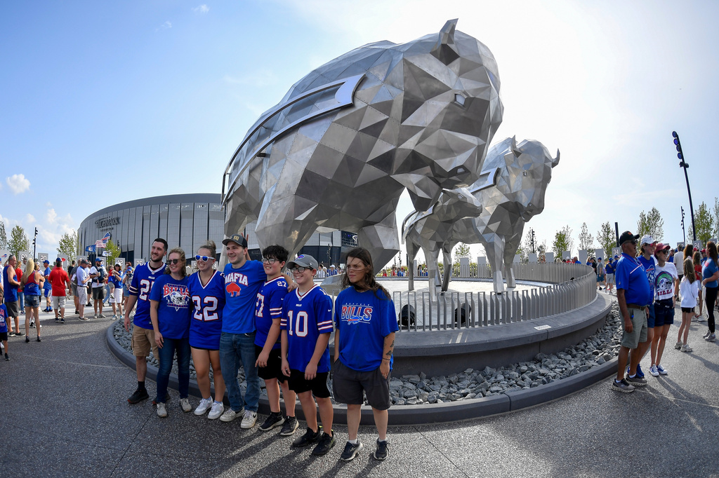Buffalo Bills fans pose for photos outside of Highmark Stadium before practice at the team's NFL football training camp Saturday, Aug. 8, 2026, in Orchard Park, N.Y. (AP Photo/Adrian Kraus)