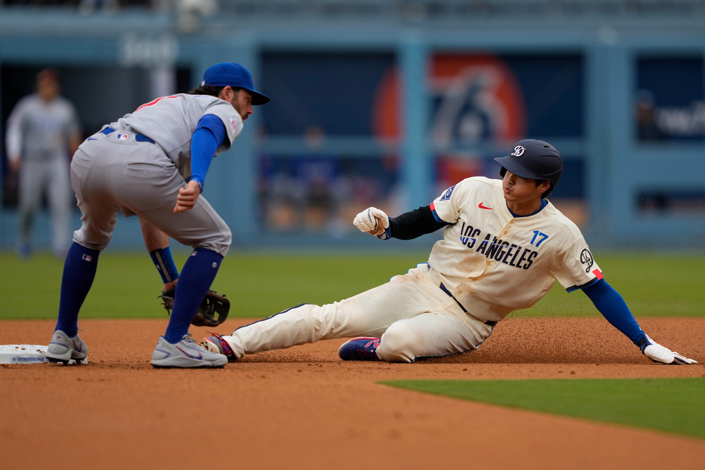 Los Angeles Dodgers' Shohei Ohtani, right, steals second as Chicago Cubs shortstop Dansby Swanson waits without the ball during the first inning of a baseball game Saturday, April 25, 2026, in Los Angeles. (AP Photo/Mark J. Terrill)