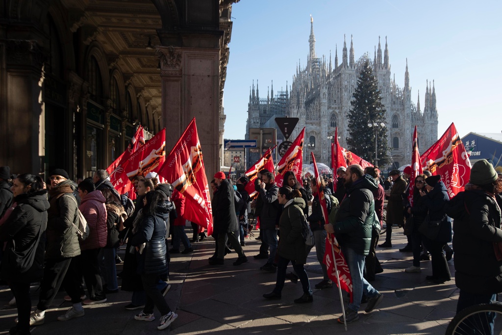 People march past the Duomo gothic cathedral on the occasion of a general strike called by the CGIL (Italian General Confederation of Labour) trade union to protest against the budget law in Milan, Italy, Friday, Dec. 12, 2025. (Marco Ottico/Lapresse/LaPresse via AP)