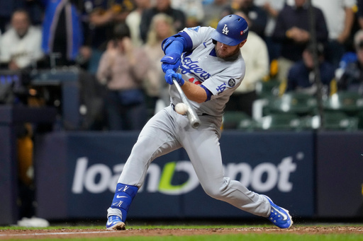 Los Angeles Dodgers' Max Muncy hits a home run against the Milwaukee Brewers during the sixth inning in Game 2 of baseball's National League Championship Series, Tuesday, Oct. 14, 2025, in Milwaukee. (AP Photo/Ashley Landis) Los Angeles Dodgers' Max Muncy hits a home run against the Milwaukee Brewers during the sixth inning in Game 2 of baseball's National League Championship Series, Tuesday, Oct. 14, 2025, in Milwaukee. (AP Photo/Ashley Landis)